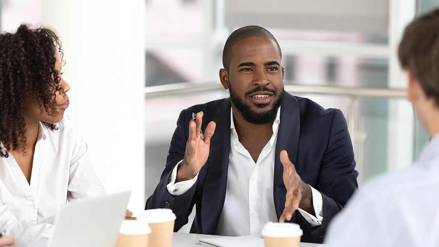 Meritus Group Business Brokerage experts mediating a negotiation between prospective buyers and sellers, bridging the price gap for a harmonious deal.
