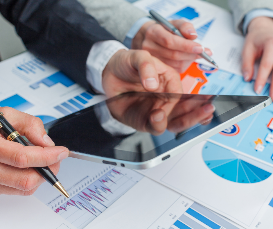 Business owner reviewing documents with a financial expert, understanding the true worth of their enterprise.