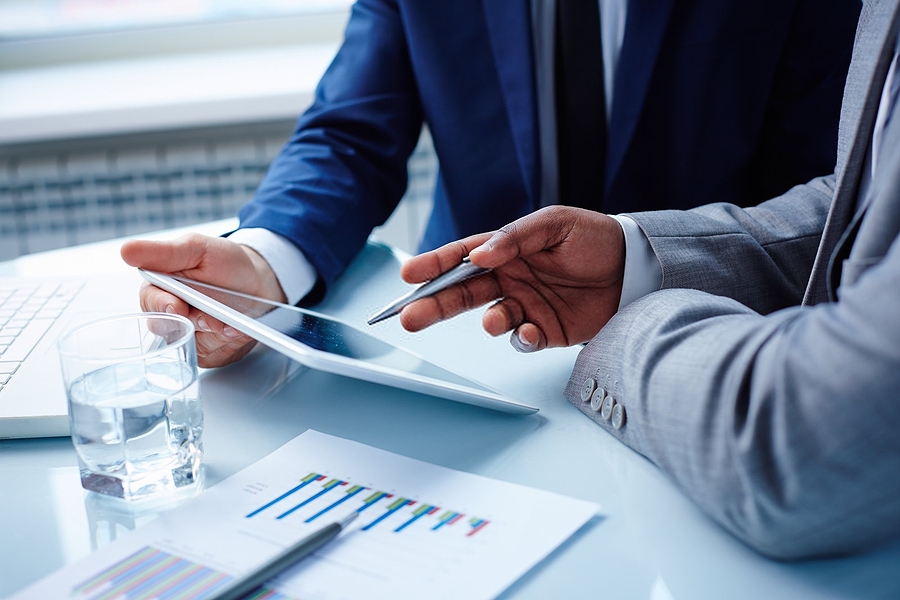 Business professionals engaged in discussion, emphasizing the importance of addressing the top questions buyers have when considering a business purchase.