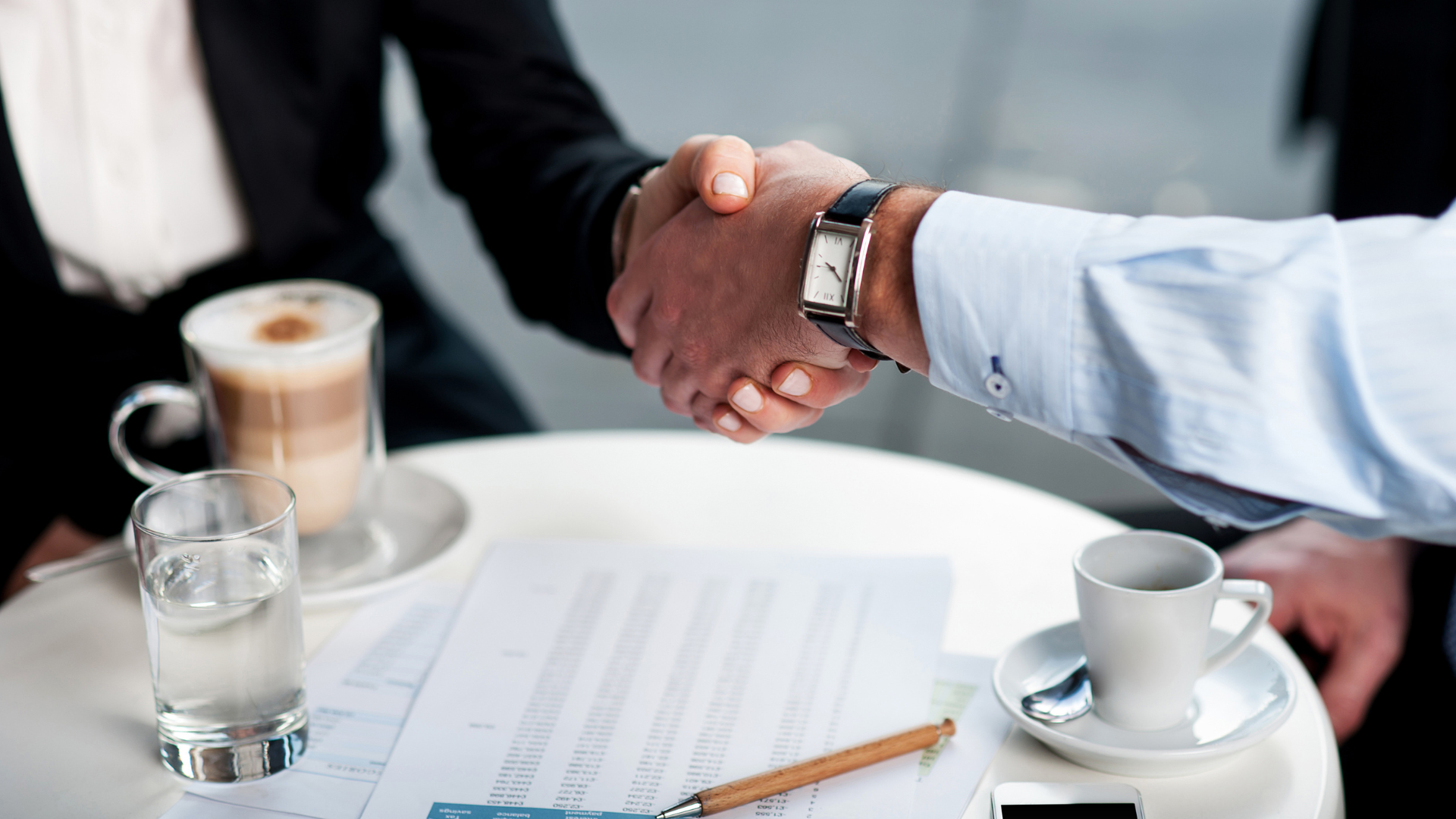 Business professionals engaged in a complex sale negotiation representing Meritus Group's strategic approach.